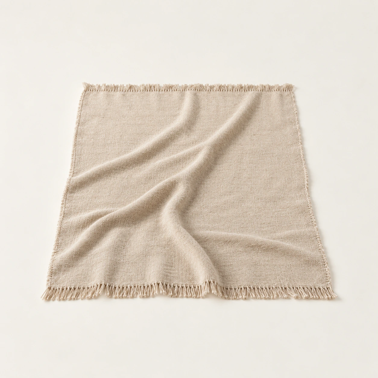 Woven throw in oat, an illustrative concept product on a warm neutral background